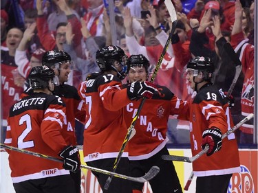 Canada's Nic Petan (19) celebrates after scoring his third goal of the game during the third period of semifinal hockey action against Slovakia at the IIHF World Junior Championship in Toronto on Sunday, Jan.4, 2015.