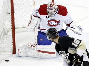 Montreal Canadiens goalie Carey Price (31) stops a shot by Pittsburgh Penguins' Brandon Sutter (16) during the second period of an NHL hockey game in Pittsburgh, Saturday, Jan. 3, 2015.