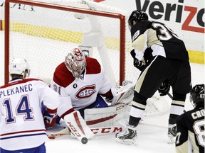 Canadiens goalie Carey Price stops a shot by the Penguins' David Perron during game in Pittsburgh on Jan. 3, 2015.