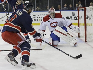 Montreal Canadiens goalie Carey Price (31) defends the net against a shot at goal by New York Rangers defenceman Kevin Klein (8) during the second period of the NHL hockey game Thursday, Jan. 29, 2015 at Madison Square Garden in New York.