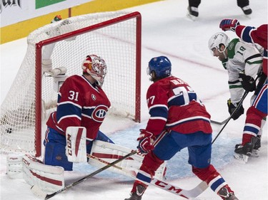 Dallas Stars' Patrick Eaves scores past Montreal Canadiens goalie Carey Price as Canadiens' Tom Gilbert (77) and Tomas Plekanec (14) look on during second period NHL hockey action Tuesday, January 27, 2015 in Montreal.