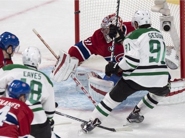 The puck goes off the goal post behind Montreal Canadiens goalie Carey Price on a shot by Dallas Stars' Tyler Seguin during first period NHL hockey action Tuesday, January 27, 2015 in Montreal.