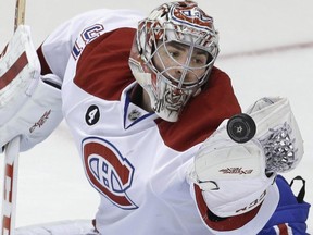 Montreal Canadiens goalie Carey Price (31) reaches for the puck during the second period of an NHL hockey game against the Dallas Stars Saturday, Dec. 6, 2014, in Dallas.