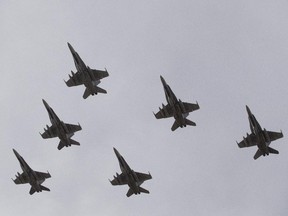 CF-18 Hornets fly in formation on their the departure for Operation IMPACT, in Cold Lake, Alberta on Tuesday October 21, 2014.