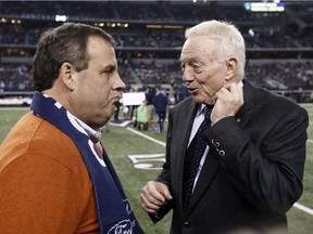 New Jersey Gov. Chris Christie, left, talks with Dallas Cowboys owner Jerry Jones on the field before a game against the Indianapolis Colts on Dec. 21, 2014, in Arlington, Tex.