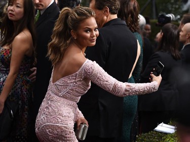 Chrissy Teigen arrives at the 72nd annual Golden Globe Awards at the Beverly Hilton Hotel on Sunday, Jan. 11, 2015, in Beverly Hills, Calif.
