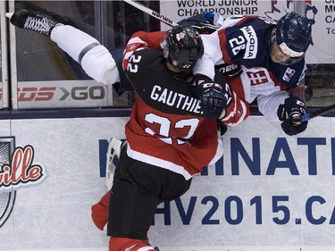 Canada forward Fredrik Gauthier (22) hits Slovakia defenceman Christian Jaros (26)during third period semifinal hockey action at the IIHF World Junior Championships in Toronto on Sunday, January 4, 2015.