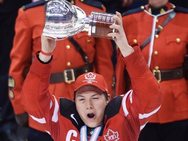 Canada captain Curtis Lazar hoists the championship trophy after defeating Russia during third period gold medal hockey action at the IIHF World Junior Championships in Toronto on Monday, January 5, 2015.