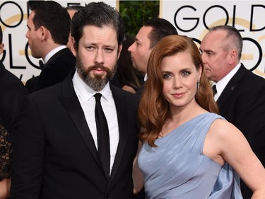Darren Le Gallo, left, and Amy Adams, wearing a Versace gown, arrive at the 72nd annual Golden Globe Awards at the Beverly Hilton Hotel on Sunday, Jan. 11, 2015, in Beverly Hills, Calif.