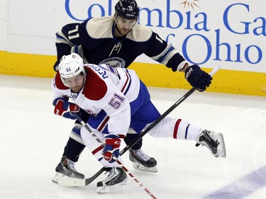 Montreal Canadiens' David Desharnais (51) works for the puck against Columbus Blue Jackets' Nick Foligno during the third period of an NHL hockey game in Columbus, Ohio, Wednesday, Jan. 14, 2015. Montreal won 3-2.