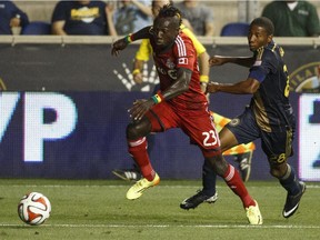 Dominic Oduro, with Toronto FC, drives to the goal with the Philadelphia Union's Raymon Gaddis giving chase during MLS game on Sept. 3, 2014, in Chester, Pa.