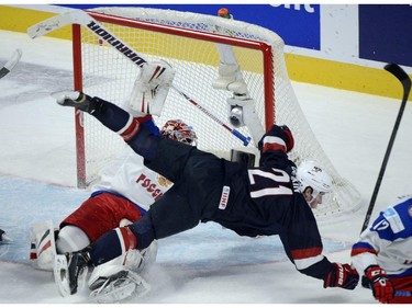 USA's Dylan Larkin runs over Russia's goaltender Igor Shestyorkin during first period quarter-final hockey action at the IIHF World Junior Championship, Friday, January 2, 2015 in Montreal.