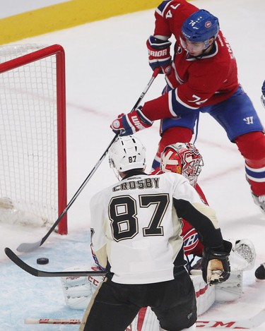 Montreal Canadiens defenseman Alexei Emelin stops puck going into the net after sliding past goalie Carey Price, while Pittsburgh Penguins Sidney Crosby closes in, during overtime period in NHL action in Montreal on Saturday January 10, 2015. (Pierre Obendrauf / MONTREAL GAZETTE)