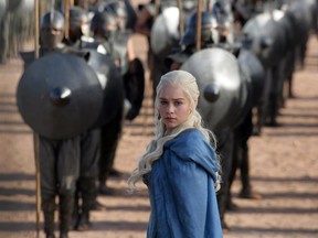 FILE - This file publicity image released by HBO shows Emilia Clarke as Daenerys Targaryen in a scene from "Game of Thrones."  The elaborate fantasy saga received a leading 24 Emmy Awards nominations Thursday, and the series is a contender again for top drama honours, an award that has eluded it since it debuted in 2011.