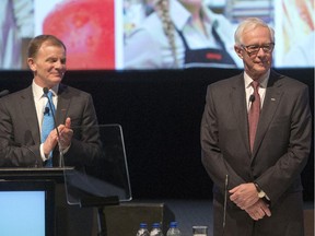 Metro Inc. outgoing Chairman Pierre Lessard, right, is applauded by chief executive Eric La Flèche and shareholders at the company's annual meeting Tuesday, January 27, 2015 in Montreal.
