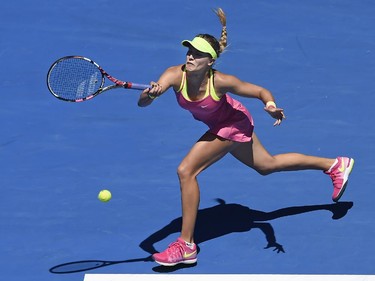 Eugenie Bouchard of Canada chases down a shot to Caroline Garcia of France during their third round match at the Australian Open tennis championship in Melbourne, Australia, Friday, Jan. 23, 2015.