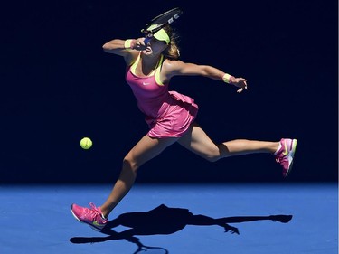 Eugenie Bouchard of Canada chases down a shot to Caroline Garcia of France during their third round match at the Australian Open tennis championship in Melbourne, Australia, Friday, Jan. 23, 2015.
