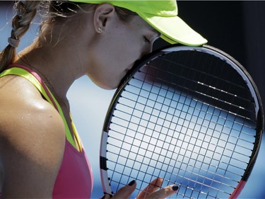 Eugenie Bouchard of Canada holds a racket as she plays Caroline Garcia of France during their third round match at the Australian Open tennis championship in Melbourne, Australia, Friday, Jan. 23, 2015.