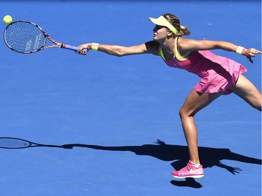 Eugenie Bouchard of Canada reaches out for a shot to Caroline Garcia of France during their third round match at the Australian Open tennis championship in Melbourne, Australia, Friday, Jan. 23, 2015.