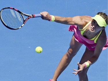 Eugenie Bouchard of Canada serves to Caroline Garcia of France during their third round match at the Australian Open tennis championship in Melbourne, Australia, Friday, Jan. 23, 2015.