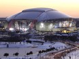 In this Feb 4, 2011 file photo, snow and ice surrounds the grounds around Cowboys Stadium as the sun sets in Arlington, Texas.