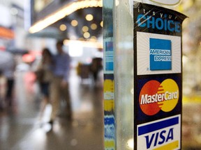In this July 27, 2007, file photo, signs for American Express, Master Card and Visa credit cards are shown on a New York store's door.