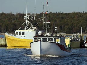 A fishing boat heads out of port to fish.