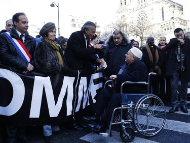 French writer Bernard Henri-Levy (C, L) talks with the Rector of Paris' Mosque Dalil Boubakeur next to Nazi Hunter Beate Klarsfeld (2ndL) during a Unity rally Marche Republicaine in Paris on January 11, 2015 in tribute to the 17 victims of a three-day killing spree by homegrown Islamists. The killings began on January 7 with an assault on the Charlie Hebdo satirical magazine in Paris that saw two brothers massacre 12 people including some of the country's best-known cartoonists, the killing of a policewoman and the storming of a Jewish supermarket on the eastern fringes of the capital which killed 4 local residents.