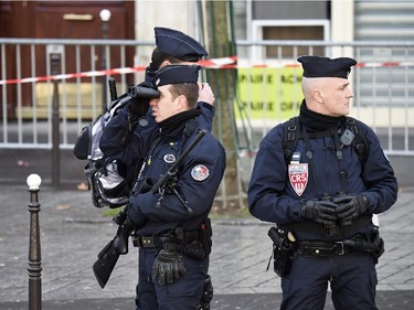 Police secure the route of the Unity rally Marche Republicaine on January 11, 2015 in Paris in tribute to the 17 victims of a three-day killing spree by homegrown Islamists. The killings began on January 7 with an assault on the Charlie Hebdo satirical magazine in Paris that saw two brothers massacre 12 people including some of the country's best-known cartoonists, the killing of a policewoman and the storming of a Jewish supermarket on the eastern fringes of the capital which killed 4 local residents.