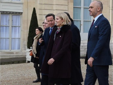 British Prime Minister David Cameron (C) and Danish Prime Minister Helle Thorning-Schmidt (2R) leave the Elysee Palace before attending a Unity rally Marche Republicaine on January 11, 2015 in Paris in tribute to the 17 victims of a three-day killing spree by homegrown Islamists. The killings began on January 7 with an assault on the Charlie Hebdo satirical magazine in Paris that saw two brothers massacre 12 people including some of the country's best-known cartoonists, the killing of a policewoman and the storming of a Jewish supermarket on the eastern fringes of the capital which killed 4 local residents.