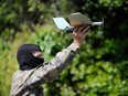 A French army Special Force soldier holds a drone during a training exercise on May 20, 2014 in Lanester, western France.