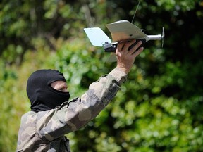 A French army Special Force soldier holds a drone during a training exercise on May 20, 2014 in Lanester, western France.