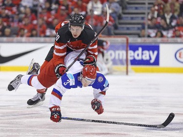Nick Paul (#20) of Team Canada is taken out by Dmitri Yudin (#3) of Team Russia during the Gold medal game in the 2015 IIHF World Junior Hockey Championship at the Air Canada Centre on January 5, 2015 in Toronto, Ontario, Canada.