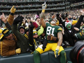 Green Bay Packers tight end Andrew Quarless celebrates a touchdown with fans during playoff game against the Dallas Cowboys on Jan. 11, 2015, in Green Bay, Wis.