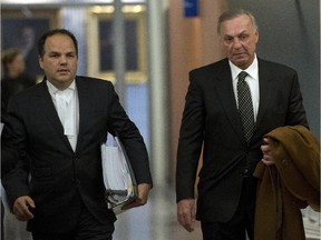 Montreal Canadiens hockey legend Guy Lafleur, right, and Alexandre Bergevin, one of his attorneys, leaves the courtroom for the lunch break in his lawsuit against the Montreal police and Quebec's attorney-general on Monday, January 12, 2015, in Montreal.