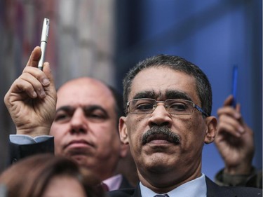 Head of the Egyptian Press Syndicate Diaa Rashwan holds a pen in a show of solidarity with the victims of Wednesday's attack in Paris on the Charlie Hebdo newspaper, at the Press Syndicate in Cairo, Egypt, Sunday, Jan. 11, 2015. The attack on the French satirical newspaper has caused grief and soul-searching around the world, and exposed the risks humorists can run in an era of instant global communications and starkly opposed ideologies. Despite the show of solidarity, some fear the violence will lead to self-censorship by artists and publishers.