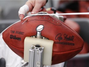 Heather Wireman laces up an official game ball for Super Bowl XLIX at the Wilson Sporting Goods Co. in Ada, Ohio, on Jan. 20, 2015.