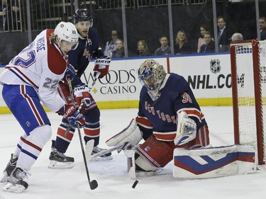 New York Rangers goalie Henrik Lundqvist, right, defends the net against Montreal Canadiens right wing Dale Weise, left, during the first period of an NHL hockey game Thursday, Jan. 29, 2015 at Madison Square Garden in New York.