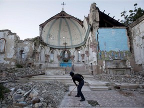 A man sweeps an exposed tiled area of the earthquake-damaged Santa Ana Catholic Church in Port-au-Prince, Haiti, in 2013. Monday marks the fifth anniversary of the earthquake.