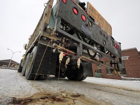 In a demonstration, a Pennsylvania Department of Transportation anti-icing truck sprays a de-icing cocktail of brine and beet juice on the driveway of PennDot's Butler, Pa., maintenance facility, Monday, Jan. 6, 2014. Because rock salt is largely ineffective below 16 degrees, additives, such as beet juice and cheese brine, can keep it working in temperatures as low as minus 25.