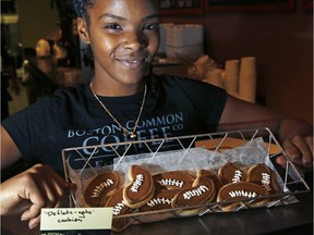 Ashleigh Fuller shows off  "Deflate-gate" cookies for sale at Boston Common Coffee in Boston's North End neighbourhood on Jan. 21, 2015.