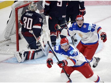 Russia's Ivan Barbashyov (22) reacts with teammate Vyacheslav Leshenko (27) after scoring his team's first goal against USA's goaltender Thatcher Demko during first period quarter-final hockey action at the IIHF World Junior Championship, Friday, January 2, 2015 in Montreal.