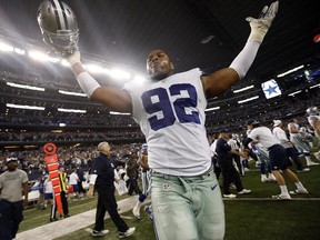 Dallas Cowboys defensive end Jeremy Mincey celebrates after an NFL wild-card playoff game against the Detroit Lions on Jan. 4, 2015, in Arlington, Tex. The Cowboys won 24-20.