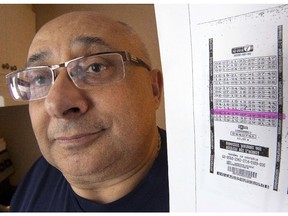 Joel Ifergan holds up a copy of his lottery ticket at his home, Thursday, January 29, 2015 in Montreal. The Supreme Court of Canada refused to hear his case claiming he is owed $13 million for having the winning numbers but the ticket was printed seven seconds after the deadline.THE CANADIAN PRESS/Ryan Remiorz