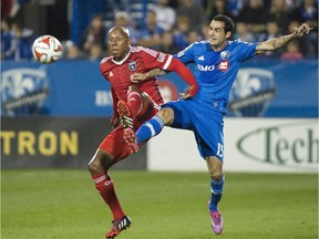 The Impact's Andres Romero, right, and the San Jose Earthquakes' Jordan Stewart battle for the ball during MLS soccer action in Montreal on Sept. 20, 2014.