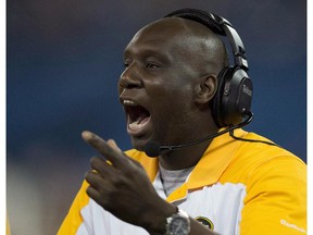 Edmonton Eskimos head coach Kavis Reed calls in plays during first half CFL Eastern Semi-Final action against the Toronto Argonauts in Toronto on Sunday November 11, 2012. The Eskimos have fired Reed.