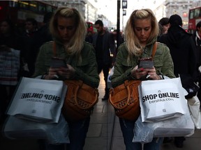 A woman shops and texts, December 2014.