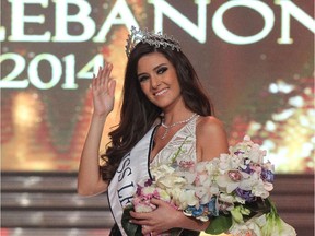 (FILES) - A file picture taken in Beirut on October 5, 2014, shows Saly Greige waving after being crowned Miss Lebanon 2014. Miss Universe contestants are keen to proclaim their desire for world peace, but Greige, this year's Miss Lebanon, has declared war after claiming Miss Israel had pushed her way into a now widely-circulated Instagram photo showing the Middle Eastern beauties with Miss Japan and Miss Slovenia in Miami in January 2015.