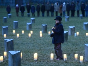 A girl holds a candle at a memorial rally to commemorate the victims of the Nazi concentration camp Auschwitz on the 70th anniversary of its liberation, in Terezin, about 70 kilometres north of Prague, Czech Republic, on Tuesday, Jan. 27, 2015.  Terezin was the seat of a concentration camp and an internment ghetto for European Jews during the war. Many Terezin prisoners were transported to Oswiecim.