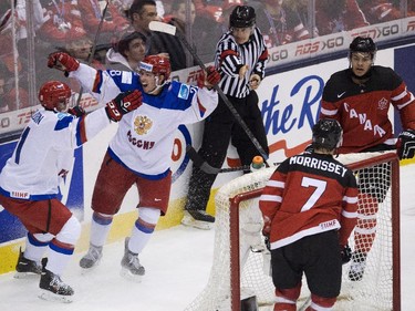 Russia forward Nikolai Goldobin, left, and Sergei Tolchinski celebrate a goal past Canada defenceman Josh Morissey (7) and Madison Bowey, back right, during second period gold medal hockey action at the IIHF World Junior Championships in Toronto on Monday, January 5, 2015.